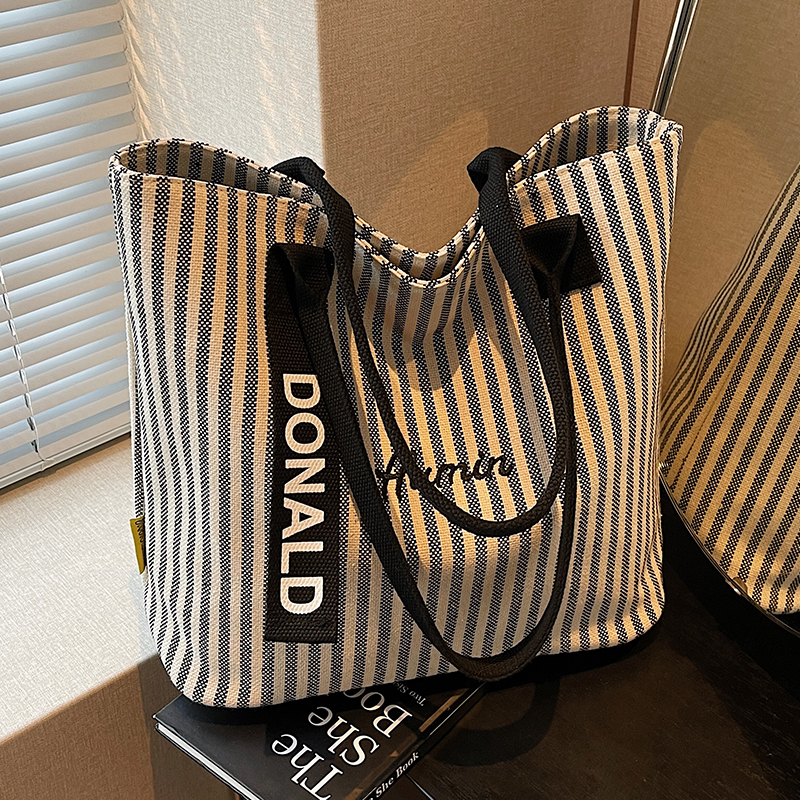 2025新款韩系条纹慵懒简约大容量通勤帆布包手提百搭托特单肩包
