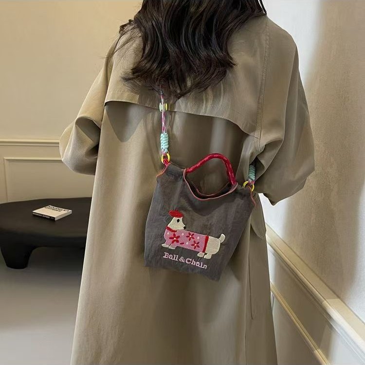日系刺绣可爱腊肠狗水桶包包女2025新款手机包百搭通勤单肩斜挎包